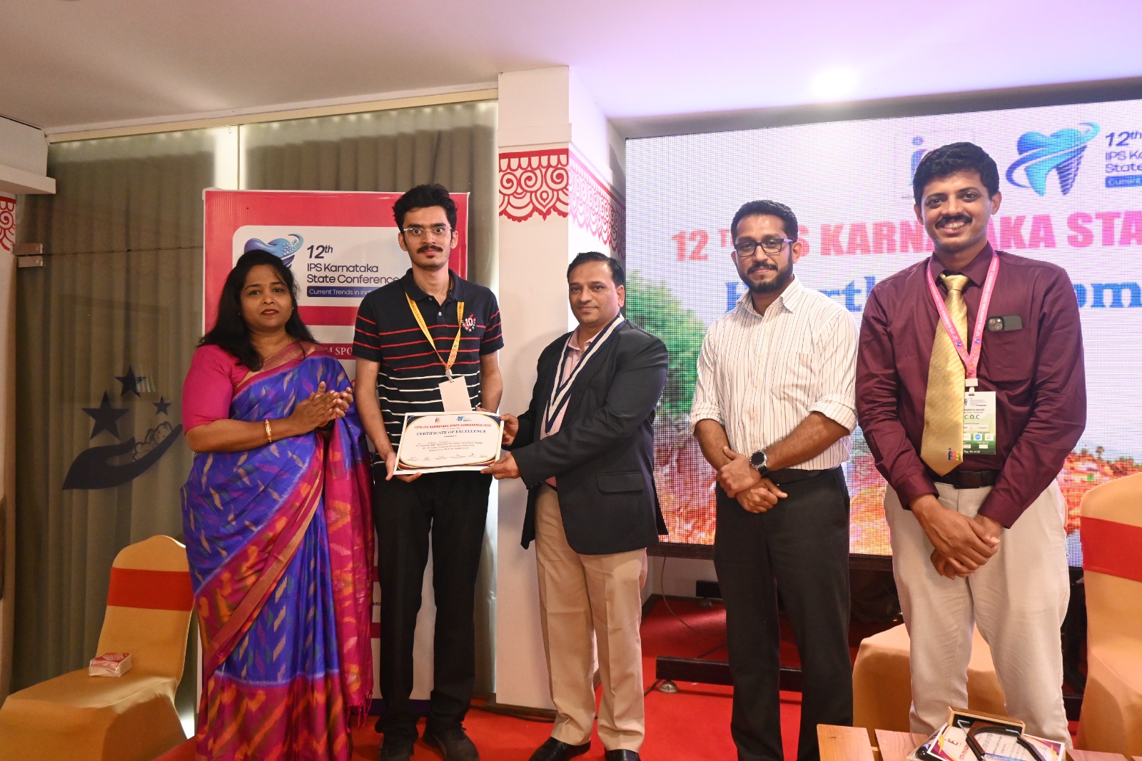 Dr. Aditya Doiphode receiving Certificate of Excellence