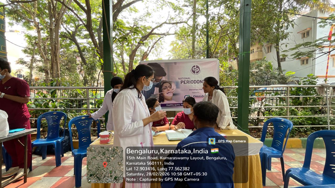 Dental professionals at a registration/screening table with a banner