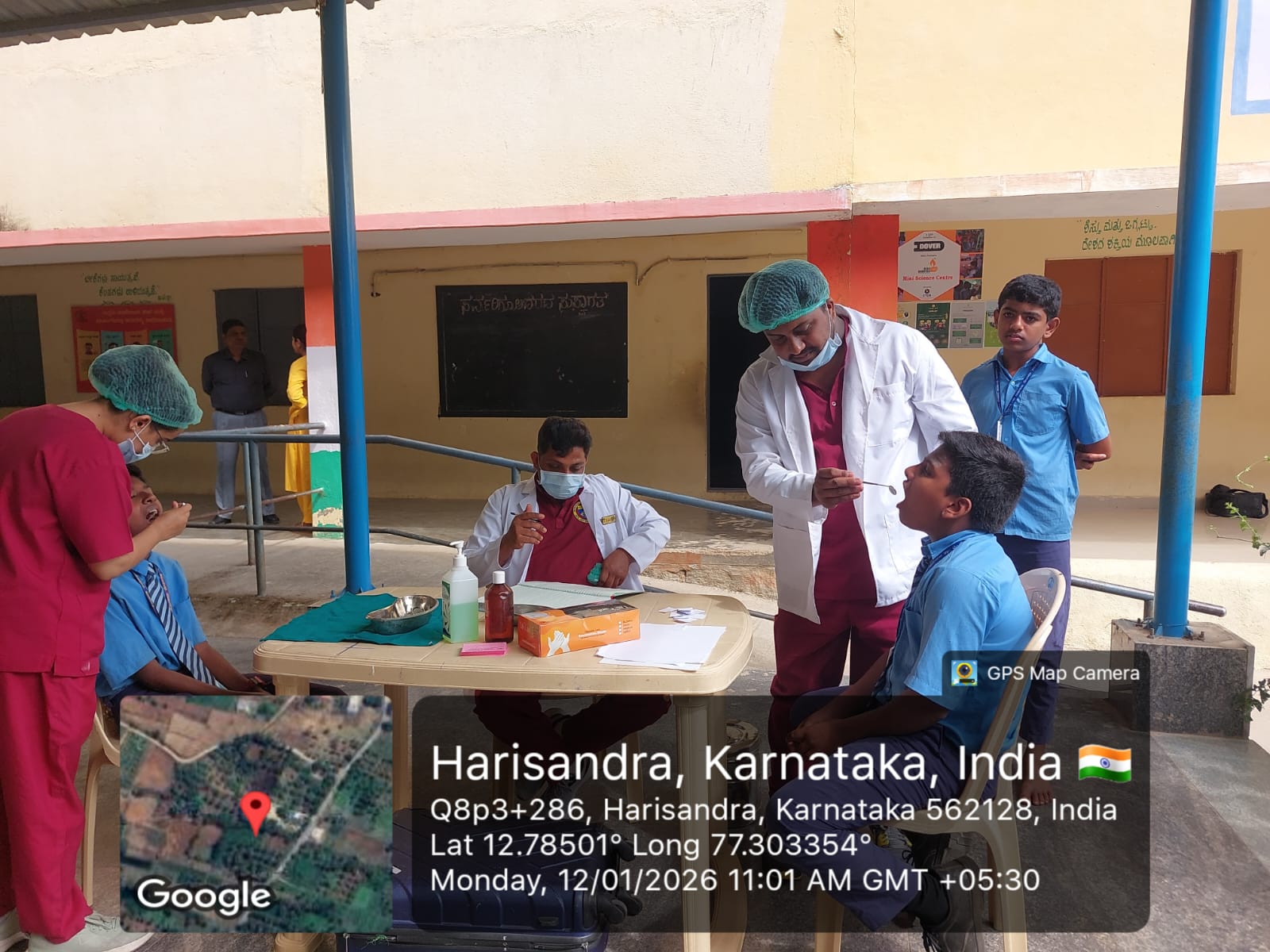 Dental team members attending to patients at a makeshift clinic outdoors