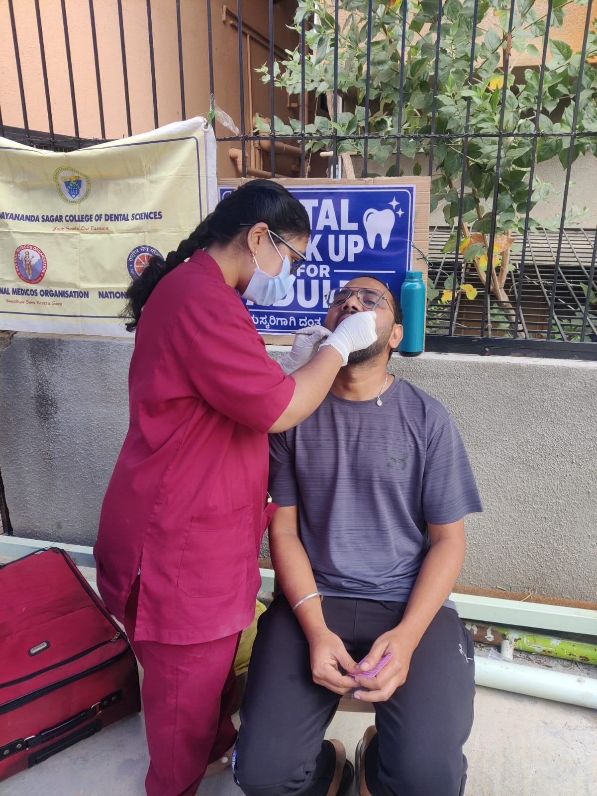 Dentist performing a dental check-up on a male patient