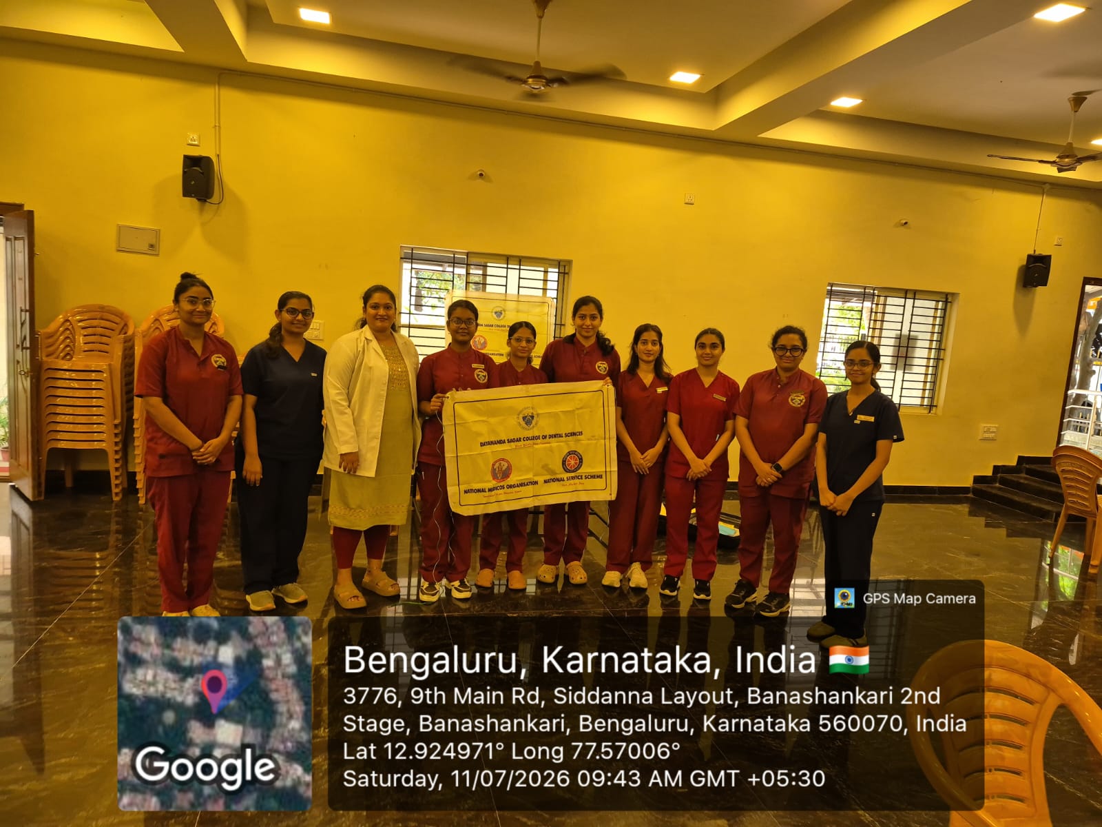 Group photo of the dental team holding a banner inside the camp venue