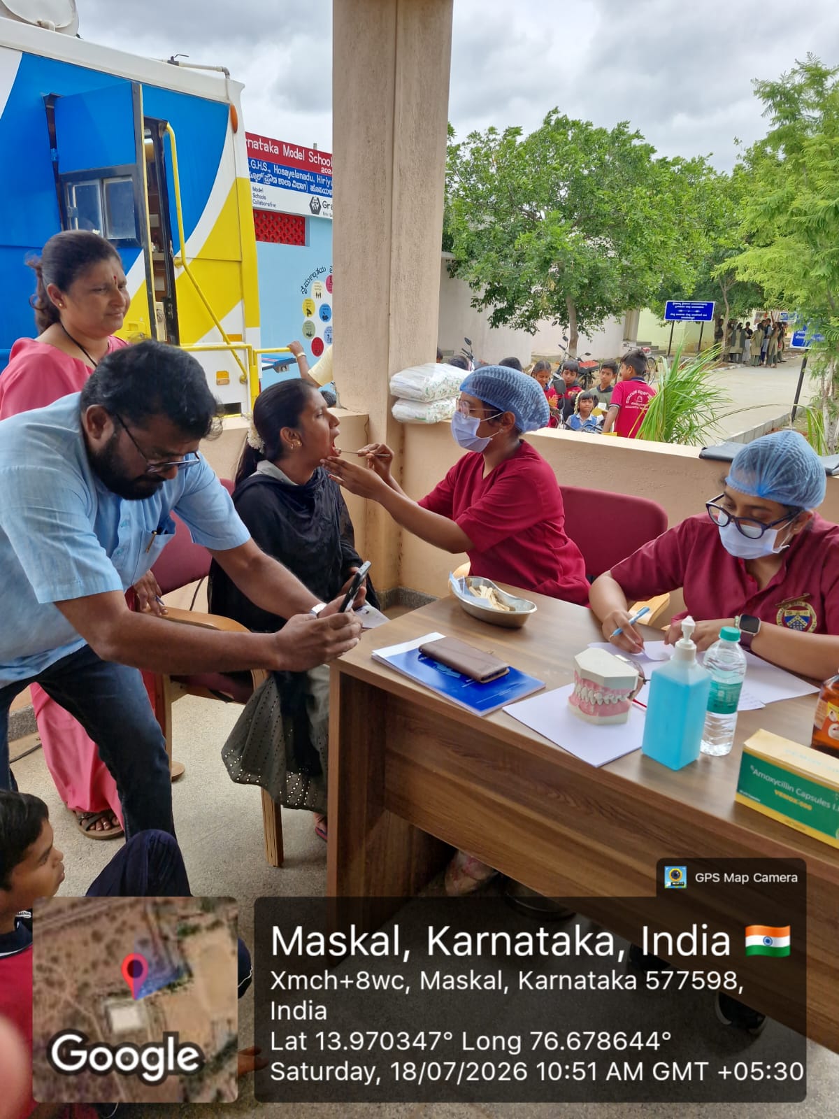 Dentists conducting oral examinations at a registration desk
