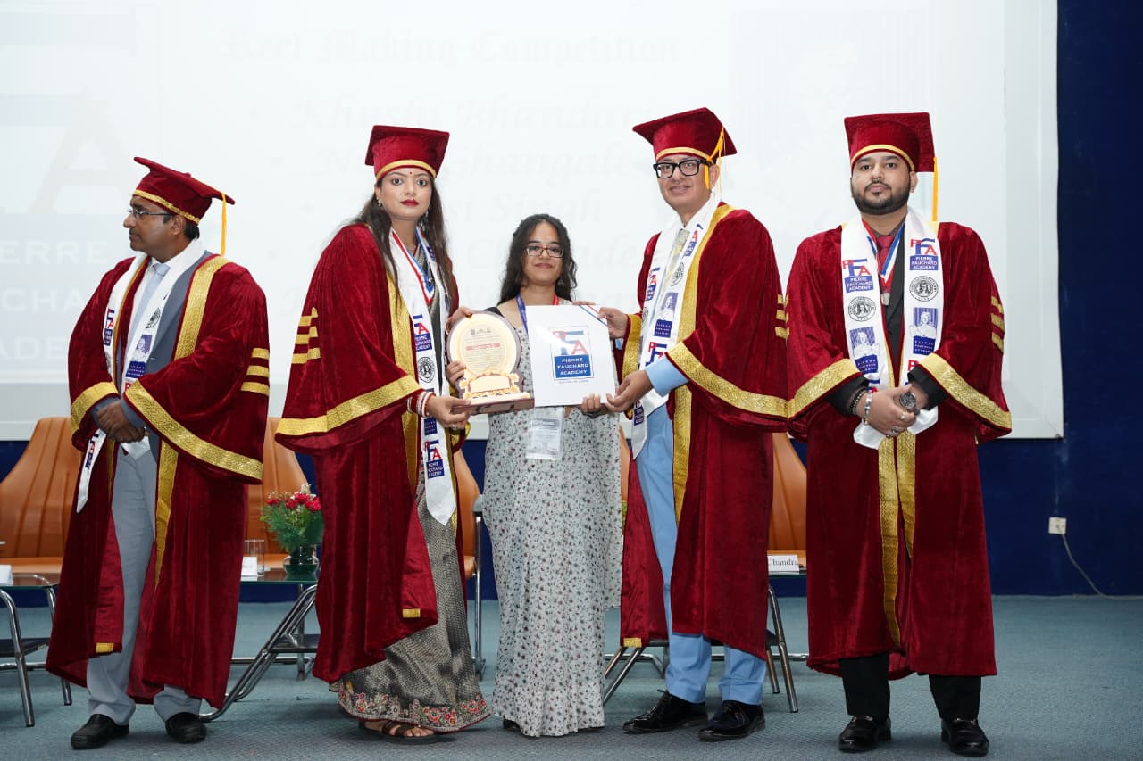 Group photo of awardees and faculty with their trophies in an office setting