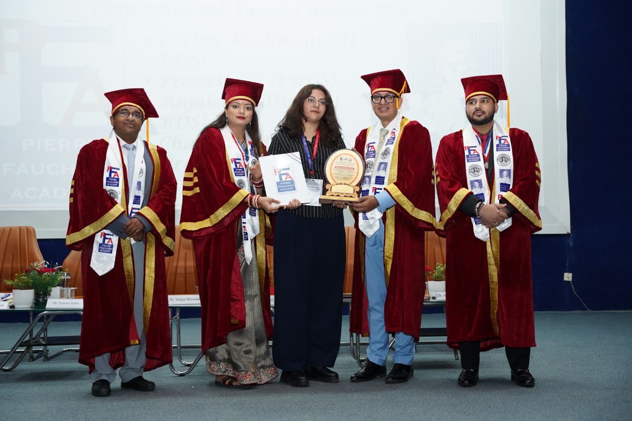 Astha receiving the Dental Reel Competition award from faculty
