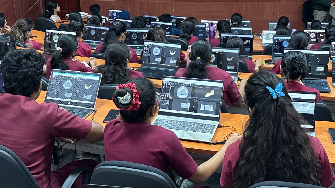 Delegates performing hands-on CBCT software planning on laptops